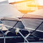 Row of boats in storage for the winter under the awning. Warehouse on the boat pier. Concept preparation for winter.