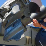 man changing propeller on outboard motor. Repairing outboard motor for boat, replacing screw